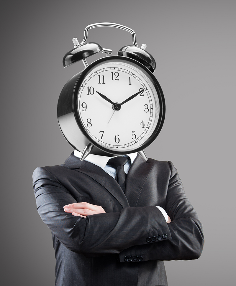 Businessman with alarm clock on head